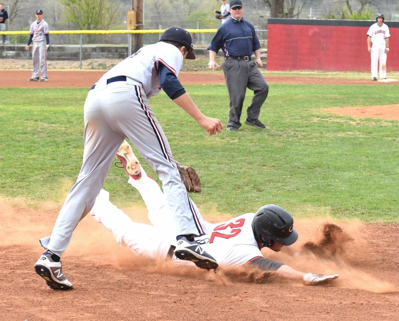 RICK PECK/Special to McDonald County Press McDonald County's Oakley Roessler tries to get under the tag of Joplin third baseman Josh Wells during the Mustangs' 10-7 win on April 21 at MCHS.