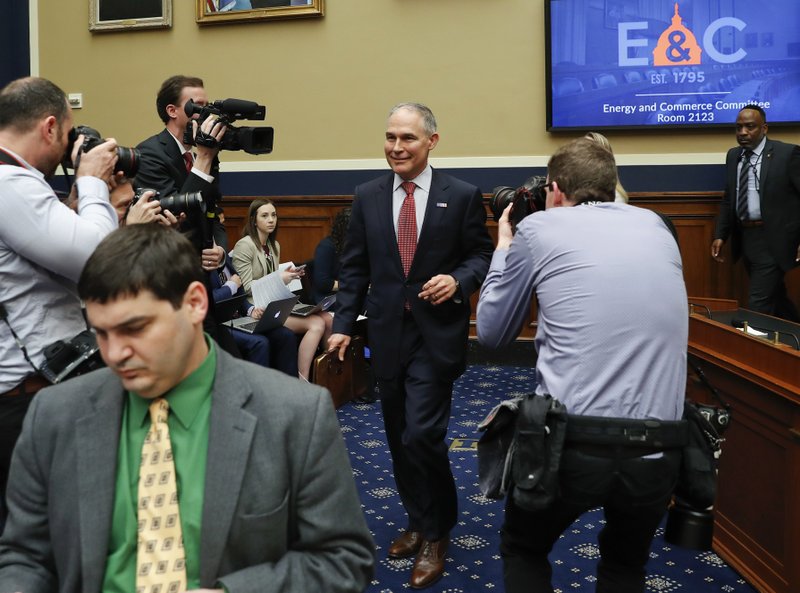 Environmental Protection Agency Administrator Scott Pruitt arrives to testify before the House Energy and Commerce subcommittee hearing on Capitol Hill in Washington, Thursday, April 26, 2018. Sitting next to Pruitt is Holly Greaves, EPA Chief Financial Officer. (AP Photo/Pablo Martinez Monsivais)

