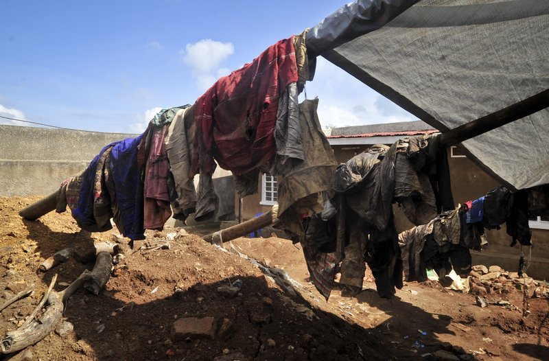 Clothes of genocide victims whose bodies were exhumed last week hang outside at the site of a recently-discovered mass grave in Gasabo district, near the capital Kigali, in Rwanda Thursday, April 26, 2018. Mass graves that authorities say could contain more than 2,000 bodies have been discovered in Rwanda nearly a quarter-century after the country's genocide. 