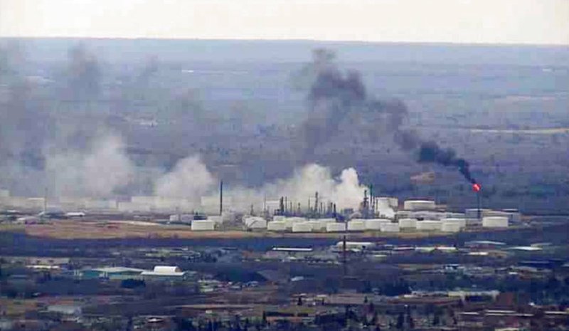 This image from video provided by WDIO-TV in Duluth shows smoke rising from the Husky Energy oil refinery after an explosion Thursday morning, April 26, 2018 in Superior, Wis. Authorities say several people were injured in the explosion. (WDIO-TV via AP)