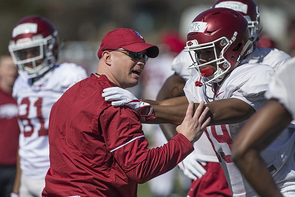 Arkansas receivers coach Justin Stepp works with receiver Tyson Morris on Saturday, March 3, 2018, in Fayetteville.