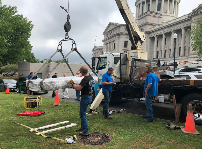 Workers install a new Ten Commandments monument on the grounds of the state Capitol on Thursday.