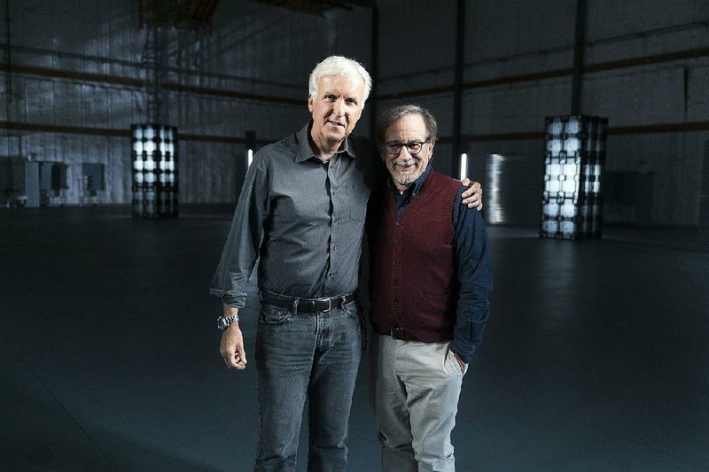 James Cameron (left) poses with Steven Spielberg during the fi lming of James Cameron’s Story of Science Fiction. The series debuts at 9 p.m. Monday on AMC. 
