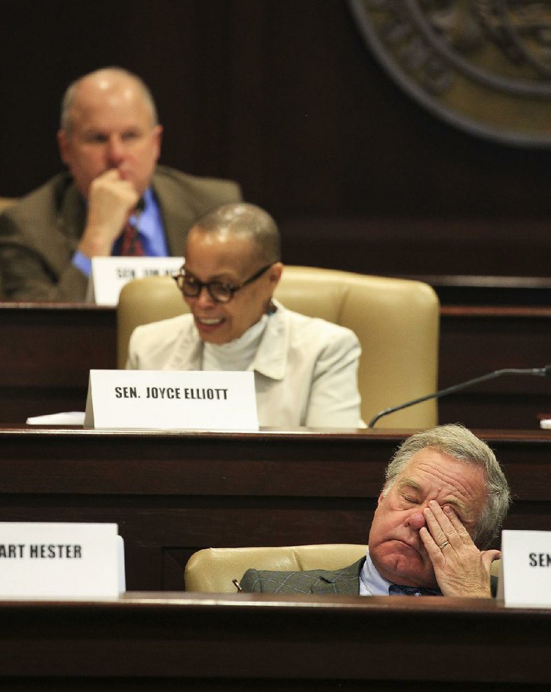 State senators and legislative tax overhaul task force members Jim Hendren (top), R-Sulphur Springs, Joyce Elliott, D-Little Rock, and Keith Ingram, D-West Memphis, take part in Thursday’s session. 