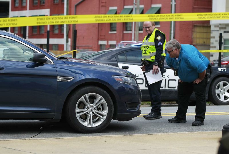 Little Rock police officers investigate after a vehicle hit and seriously injured a pedestrian at East Fourth and Cumberland streets Thursday.