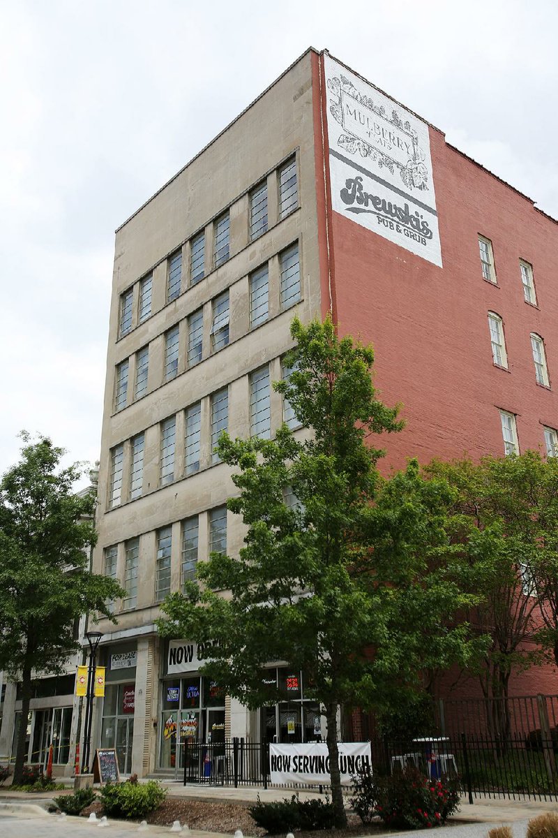 The sign advertising the Brewski’s Pub and Grub restaurant and the Mulberry Flats apartments will remain on the south side of the building at 315 Main St. in Little Rock. 
