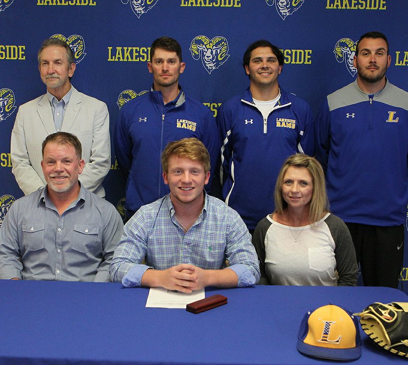 The Sentinel-Record/Richard Rasmussen SIGNING DAY: Lakeside senior Zac Melugin, sitting center, signed a national letter of intent to play baseball for Mineral Area College Wednesday at Lakeside High School. Joining Melugin, in front, from left, were his father Tony Melugin and mother Tammy Melugin, and back, from left, former coach Tommy Jester, Lakeside head coach Leighton Hardin, assistant coach Barrett Bock and assistant coach Bryan Bolt.