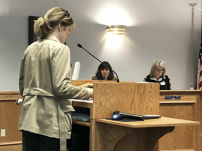 NWA Democrat-Gazette/STACY RYBURN Megan Hurley, Fayetteville School Board member, speaks Thursday to Joy Shirley, director of student services for the district, during the board's meeting.