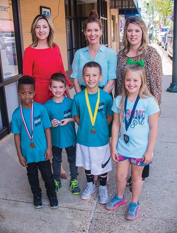 The Andy Allison Super Kids Fun Run will begin at 10:30 a.m. Saturday during Downtown Crawfest in Arkadelphia. Making plans for the event are, front row, from left, Donovan Phifer, Emmett Price, Andy McDill and Addy Caldwell, who will participate in the fun run; and back row, Shelley Loe, executive vice president of the Arkadelphia Area Chamber of Commerce; Cindy McDill, sister to the late Andy Allison, for whom the run is named; and Stacey Marlar, senior vice president, Southern Bancorp, sponsor of the event. All participants will receive a medal and a T-shirt. Trophies will be awarded to winners in each age division, and four new bicycles will be given away during a drawing.
