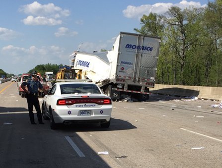Responders from Arkansas State Police and the Arkansas Department of Transportation at the scene of a rollover wreck involving two 18-wheelers that killed at least one person on April 27, 2018.