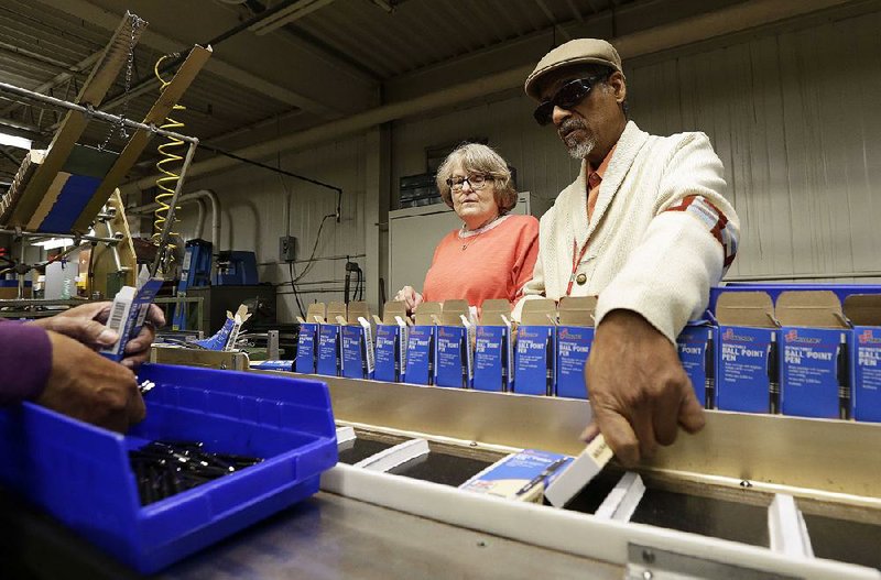 Lynn Larsen and Clifford Alexander box Skilcraft U.S. Government pens recently at the Industries for the Blind plant in Greensboro, N.C. Larsen and Alexander have worked at the plant for decades. 
