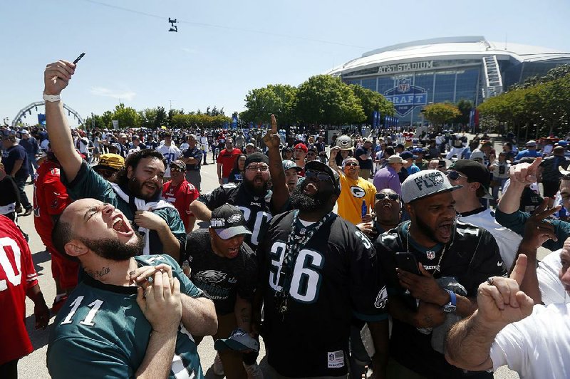Philadelphia Eagles fans celebrate at the NFL Experience before the start of the draft Thursday at AT&T Stadium in Arlington, Texas. 