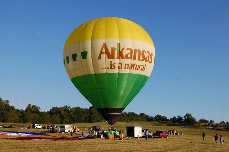 File Photo/Arkansas Democrat-Gazette/BILL BOWDEN Austin Albers piloted the "Arkansas is a Natural" balloon, which served as the "hare" in the Hare and the Hound Race in 2014 in Harrison. Other balloon pilots follow the Arkansas balloon to an undisclosed location, where they dropped bean bags on a target on the ground below. It was the first event in the annual Arkansas Hot Air Balloon State Championship. Albers is general manager of the Buffalo Outdoor Center in Ponca.