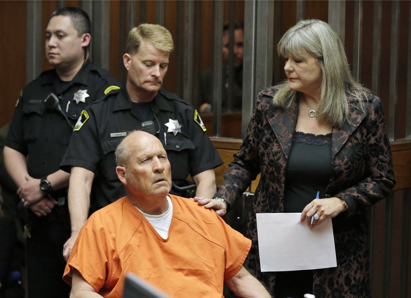James Joseph DeAngelo, 72, who authorities suspect is the so-called Golden State Killer responsible for at least a dozen murders and 50 rapes in the 1970s and 80s, is accompanied by Sacramento County Public Defender Diane Howard, right, as he makes his first appearance, Friday, April 27, 2018, in Sacramento County Superior Court in Sacramento, Calif. (AP Photo/Rich Pedroncelli)