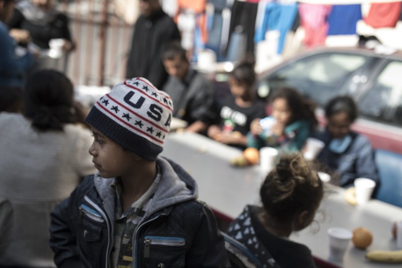 Children have their breakfast at the "Vina de Tijuana AC" migrant shelter in Tijuana, Mexico, Saturday, Arpril 28, 2018. As the migrants prepare to walk to the "Casa del Tunel" to get legal advice from U.S. immigration lawyers, they are telling Central Americans in a caravan of asylum-seekers they may be separated from their children and detained for many months. (AP Photo/Hans-Maximo Musielik)