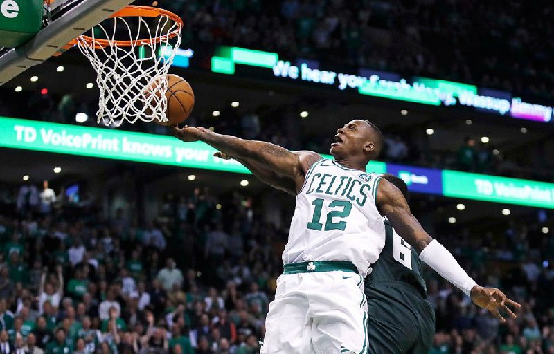 Boston Celtics guard Terry Rozier drives to the basket against the Milwaukee Bucks during the fourth quarter of Game 7 of Saturday’s first-round NBA playoff series in Boston. Rozier scored 12 of his 26 points in the last quarter as the Celtics won 112-96. 
