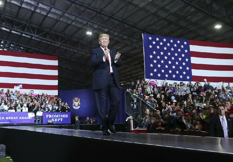 President Donald Trump takes the stage Saturday for a rally at Total Sports Park in Washington, Mich.  