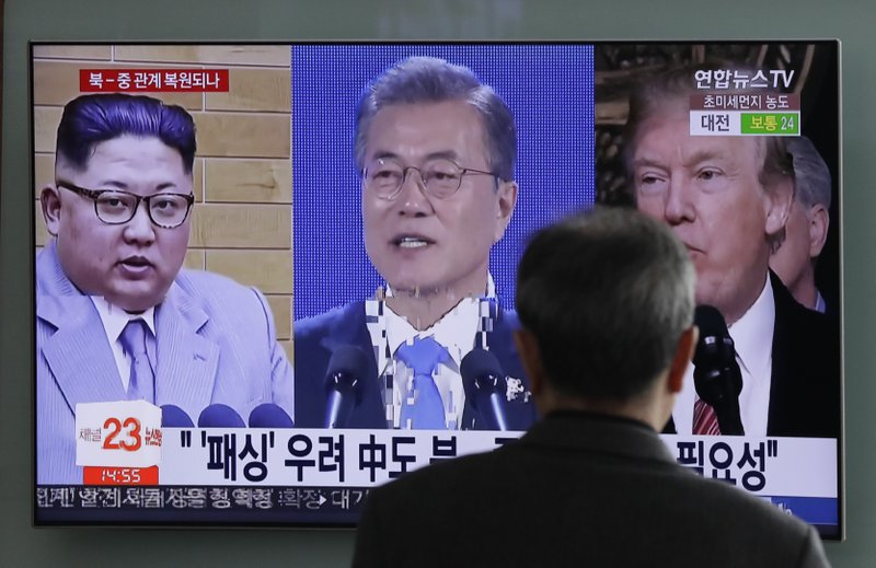 In this March 27, 2018 photo, a man watches a TV screen showing file footages of U.S. President Donald Trump, right, South Korean President Moon Jae-in, center, and North Korean leader Kim Jong Un, left, during a news program at the Seoul Railway Station in Seoul, South Korea. The stakes will be high when North Korean leader Kim Jong Un and South Korean President Moon Jae-in sit down Friday, April 27, 2018 in the no man's land that forms the world's most heavily armed border. (AP Photo/Lee Jin-man)