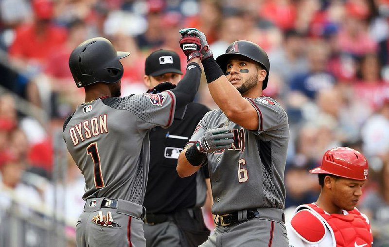 David Peralta (right) celebrates his home run with Jarrod Dyson during the Diamondbacks’ 4-3 victory over the Washington Nationals on Saturday at Nationals Park in Washington, D.C. The victory ensured the Diamondbacks opened the season with nine consecutive series victories. The only team to win more series to start the season was the 1907 Chicago Cubs, who won the World Series that year. 