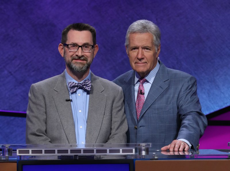 Jake Allen, a Gifted and Talented Education teacher at Huntsville Intermediate School in Huntsville, poses with Jeopardy! host Alex Trebek. Photo courtesy of Jeopardy Productions, Inc.