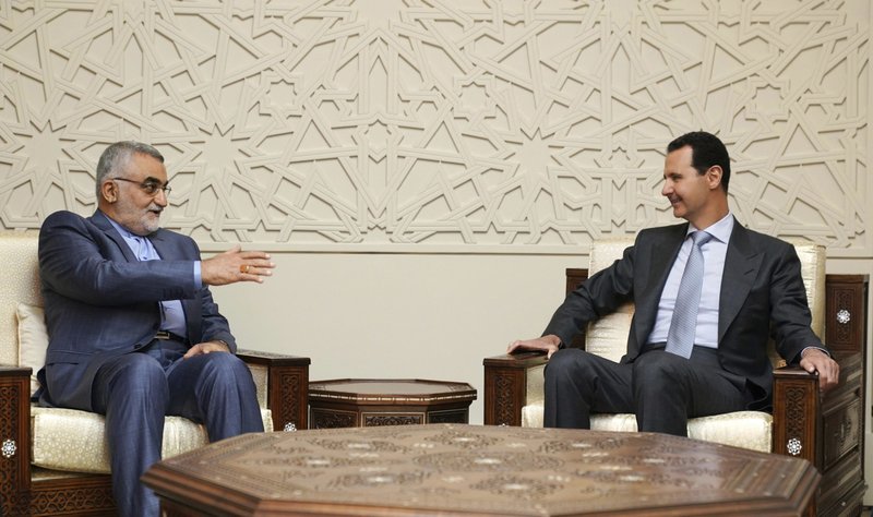 In this photo released by the Syrian official news agency SANA, Syrian President Bashar Assad, right, meets with Alaeddin Boroujerdi, left, the head of Iran's parliamentary committee on national security and foreign policy, in Damascus, Syria, Monday, April 30, 2018. The meeting came as a missile attack targeting government outposts in Syria's northern region killed at least 26 pro-government fighters, mostly Iranians, amid soaring Mideast tensions. (SANA via AP)