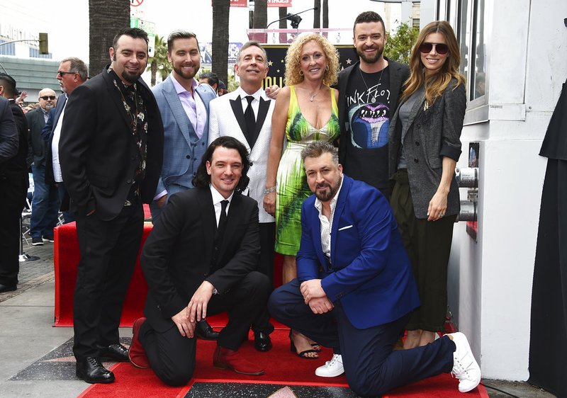 Chris Kirkpatrick, standing from left, Lance Bass, Paul Harless, Lynn Bomar Harless, Justin Timberlake, Jessica Biel, and kneeling from left, JC Chasez and Joey Fatone attend a ceremony honoring NSYNC with a star on the Hollywood Walk of Fame on Monday, April 30, 2018, in Los Angeles. (Photo by Jordan Strauss/Invision/AP)