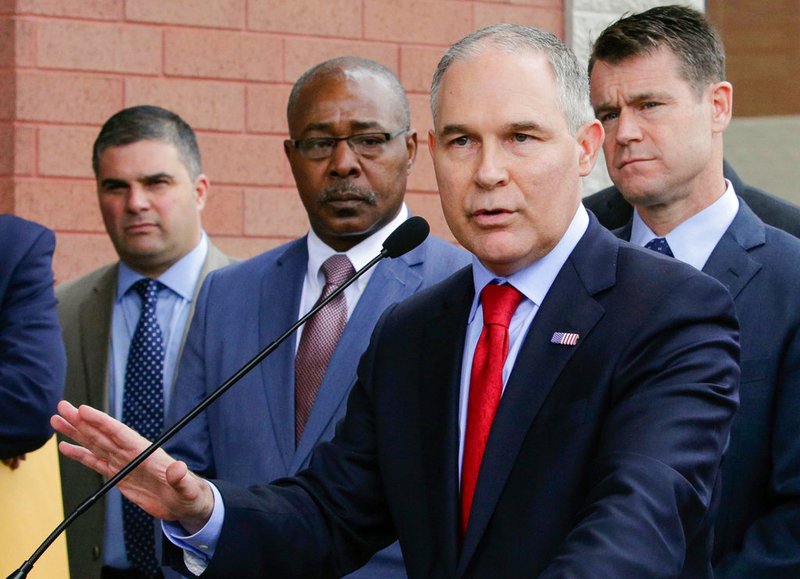 In this April 19, 2017, file photo, Environmental Protection Agency Administrator Scott Pruitt speaks at a news conference with Pasquale "Nino" Perrotta, left, in East Chicago, Ind. Pruitt is announcing the departure of two top aides amid ethics investigations at the agency. Pruitt says his security chief, Pasquale "Nino" Perrotta, was retiring. He gave no cause, but Pruitt's spending on security at the EPA is the subject of ongoing federal investigations. Pruitt also announced the departure of Albert Kelly, a former Oklahoma banker in charge of the toxic waste cleanups. (AP Photo/Teresa Crawford, File)