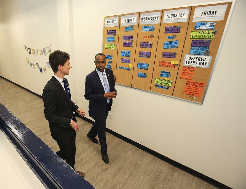 Dr. Ben Carson, (right) secretary of the U.S. Department of Housing and Urban Development, tours Our House in Little Rock on Tuesday afternoon with the agency’s executive director, Ben Goodwin. 