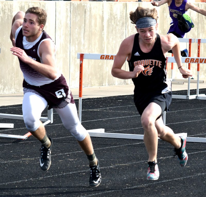 Westside Eagle Observer/MIKE ECKELS After clearing the final set of hurdles, Brandon Atwood (Gentry, left) and Caleb Brown (Gravette) sprint towards the finish line during the 2018 4A-1 District Track meet at Lions Stadium in Gravette April 24. Atwood beat Brown by .05 second to take third in the 110-meter hurdles. Brown finished in fourth place.