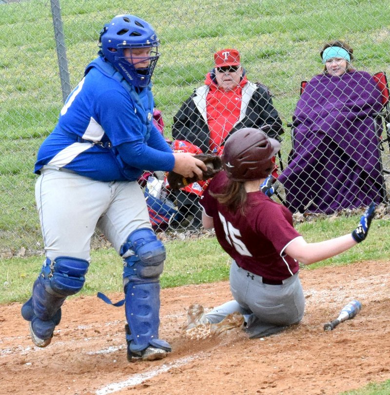 Westside Eagle Observer/MIKE ECKELS Bulldogs' catcher Bryan Ward tags a Leopard runner as she slides into home plate during the 1A Northwest District baseball tournament game between Decatur and Alpena at Edmiston Ballpark in Decatur April 26. Ward's efforts paid off as the home plate umpire ruled the runner out.