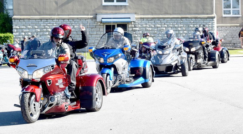 Westside Eagle Observer/MIKE ECKELS A group of motorcycles pulls out of Decatur City Hall May 5, 2017, on a 50-mile round trip to raise money for the Arkansas Children's Hospital. Motorcycles from around the four-state area will converge on Decatur City Hall once again May 5 to participate in the ninth annual Wyatt Hopkins Poker Run sponsored by the Decatur Fire Department.