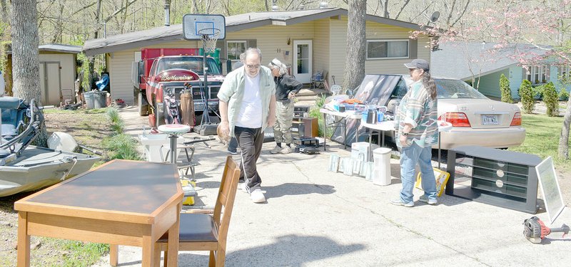 Keith Bryant/The Weekly Vista Shoppers stopped to take a look at Todd Mitchell's garage sale.