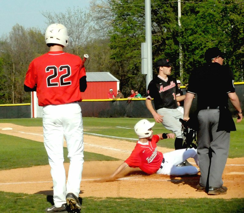 MARK HUMPHREY ENTERPRISE-LEADER Farmington freshman Tate Sutton steps out of the way as a base runner crosses home plate after passed ball against Maumelle Monday. The Cardinals won 13-2 to qualify for state and advance to the 5A West semifinals Tuesday against Greenbrier with the finals set for Friday.