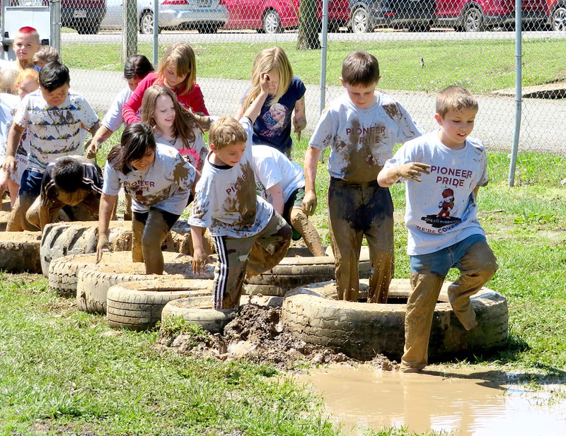 Gentry Intermediate School students go through an obstacle course in the Mud Dogger event at the school on Friday, April 27.