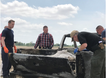 Responders from the Jonesboro Police Department, Jonesboro Fire Department and the Craighead County coroner's office investigate a completely burned pickup truck that a body was found in on May 2, 2018.