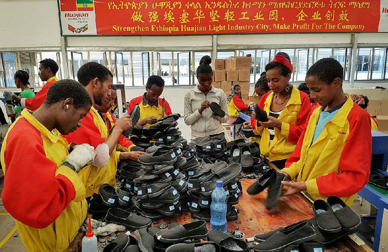 Workers sort shoes at the Huajian Group factory near Addis Ababa, Ethiopia. The Chinese company is touted in a China-backed film as spreading prosperity by hiring thousands of Ethiopians, but the workers paint a different picture.  