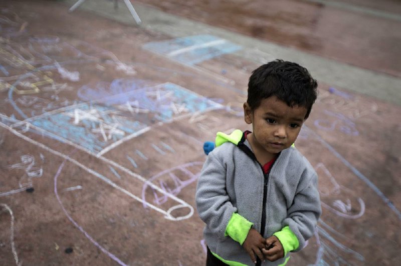 This child and numerous others are part of the caravan of Central Americans in a camp near the U.S. border crossing at Tijuana, Mexico.  