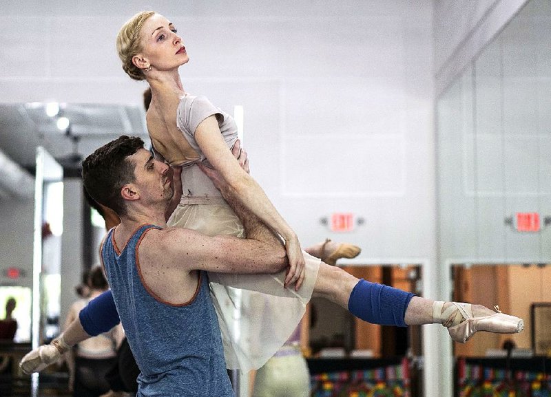 Toby Lewellen lifts Amanda Sewell in a rehearsal for Ballet Arkansas’ program this weekend.  