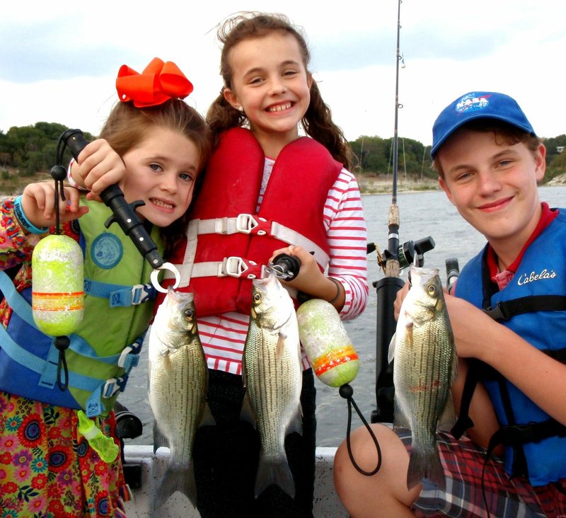 COURTESY PHOTO Young Outdoorsmen United is hosting the special annual youth fishing event Saturday, May 12, for kids ages 8-15. Participants from previous year's events were proud to show their catch while fishing on Grand Lake in Oklahoma.