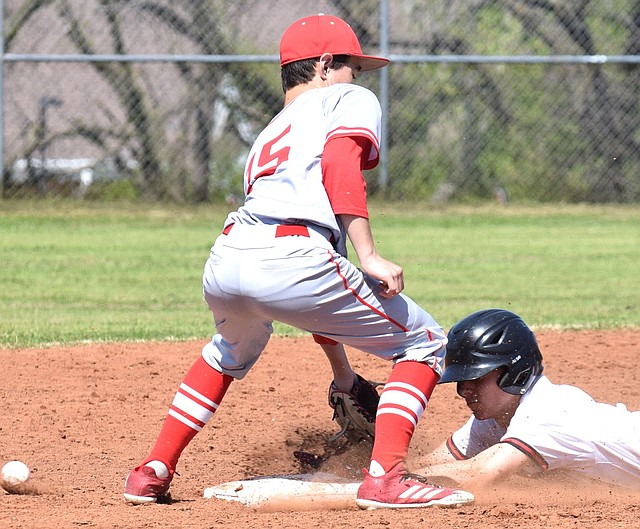 RICK PECK/SPECIAL TO MCDONALD COUNTY PRESS Tyler Stoutsenberger steals second base during McDonald County's 6-5 win over Carl Junction on April 28 at MCHS.