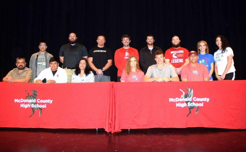 RICK PECK/SPECIAL TO MCDONALD COUNTY PRESS Teammates since fourth grade, both Isrrael De Santiago (front row, second from left) and Cole DelosSantos (front row, second from right) signed letters of intent to attend Westminster College in Fulton, Mo. on April 23 at MCHS. Front row, left to right: Rudy De Santiago, Isrrael De Santiago, Martha De Santiago, Christy DelosSantos, Cole DelosSantos and Fermin DelosSantos. Back row: Daniel De Santiago (brother),Craig Collins, Sean McCullough, Kellen Hoover, Kanon Hoover, Daniel Sumler, (MCHS football coaches) Ariel DelosSantos and Madison DelosSantos (sisters).