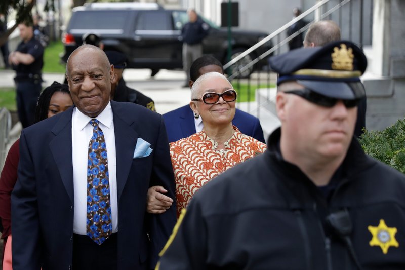 In this April 24, 2018, file photo, Bill Cosby, left, arrives with his wife, Camille, for his sexual assault trial, at the Montgomery County Courthouse in Norristown, Pa. Bill Cosby's wife is calling for a criminal investigation into the prosecutor behind his sexual assault conviction, saying the case was "mob justice, not real justice" and a "tragedy" that must be undone. Camille Cosby commented on the case for the first time on Thursday, May 3, in statement issued through a spokesman a week after her husband of 54 years was convicted of aggravated indecent assault. 