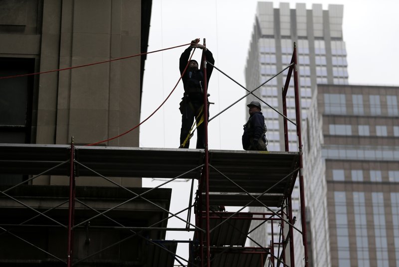In this Feb. 20, 2018, file photo, construction workers work in midtown Manhattan in New York. U.S. productivity grew at an annual rate of 0.7 percent in the first three months of 2018, a weak reading but a slight improvement from the previous quarter.