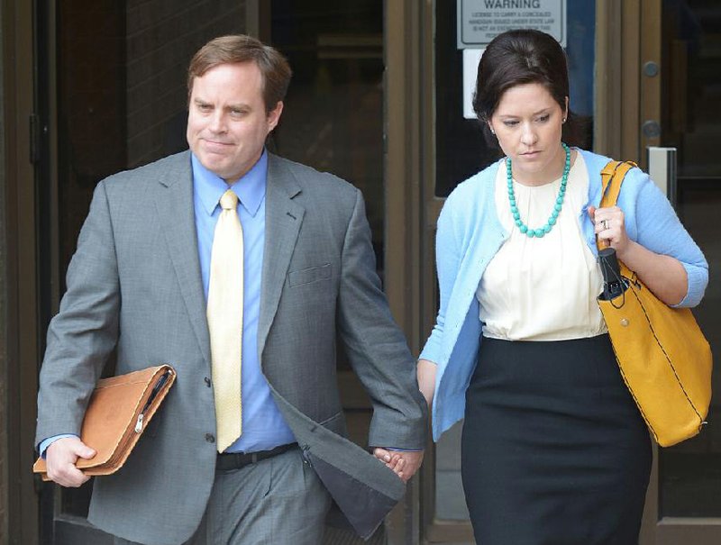 FILE — Jon Woods and his wife, Christina, leave the federal building in Fayetteville on May 4 after the former state senator was found guilty on 15 charges in a kickback scheme. 