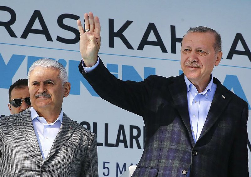 Turkish President Recep Tayyip Erdogan (right) greets supporters Saturday during a campaign rally in Kayseri. Prime Minister Binali Yildirim joins Erdogan onstage. 
