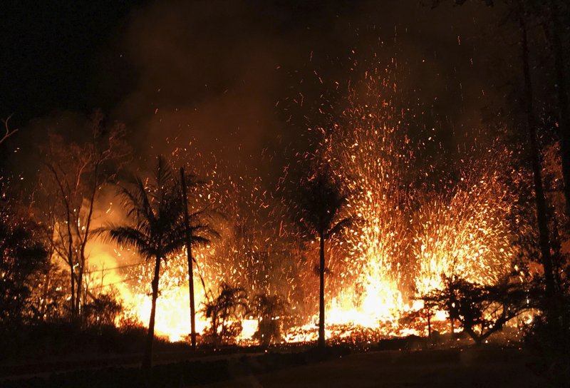 In this Saturday, May 5, 2018 photo, a new fissure erupts in Leilani Estates in Pahoa, Hawaii. Hawaii's erupting Kilauea volcano has destroyed homes and forced the evacuations of more than a thousand people. (U.S. Geological Survey via AP)