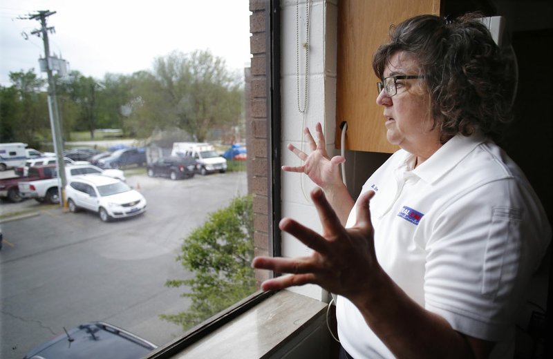 NWA Democrat-Gazette/DAVID GOTTSCHALK Becky Stewart, chief of Central EMS, describes the lack of a staging area and parking Wednesday at Station One in Fayetteville. The ambulance service has leased two rows off property next to their facility. The Washington County ambulance service must go back and compile more data before the Regional Authority will discuss ways to fund a new headquarters.