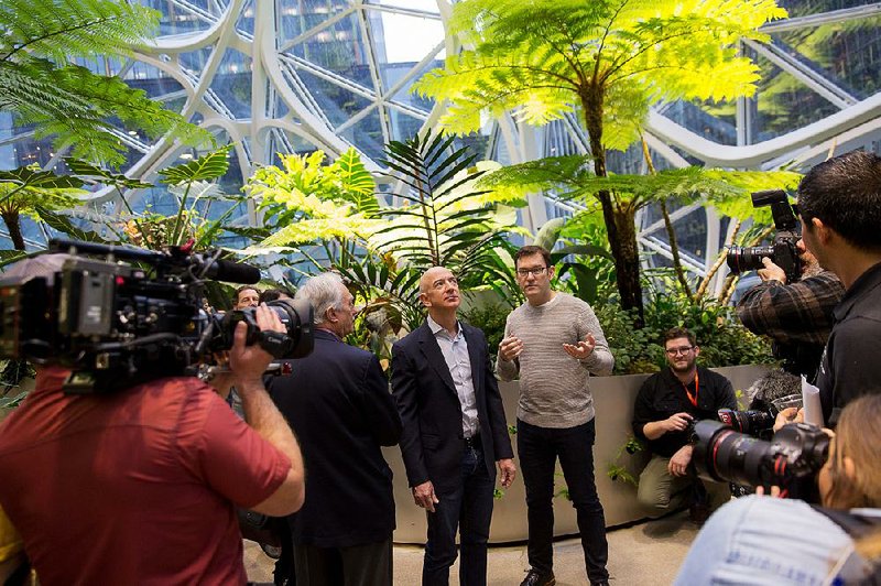 Jeff Bezos (center left), founder and chief executive officer of Amazon.com Inc., tours the Spheres during opening day ceremonies at the company’s campus in Seattle in January. 
