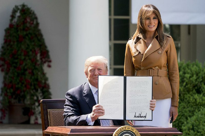  President Donald Trump and first lady Melania Trump pose together after Trump signs a proclamation during the first lady’s “Be Best” initiative Monday in the Rose Garden of the White House. 