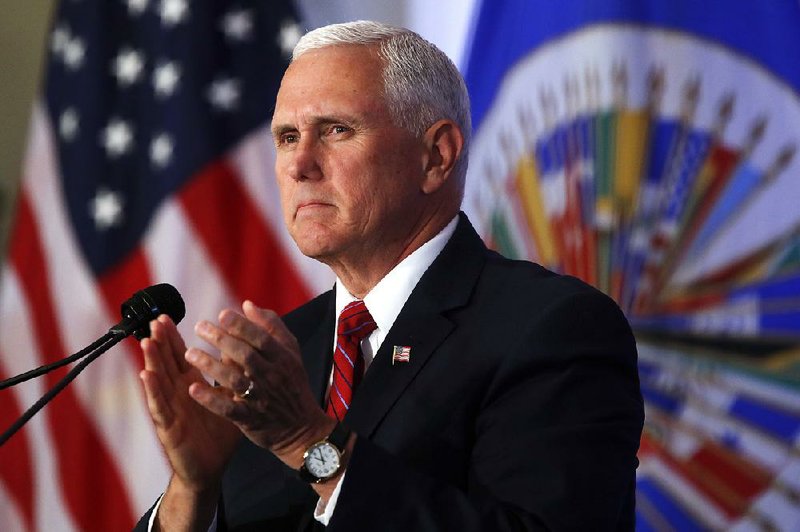 Vice President Mike Pence applauds during a speech at the Organization of American States on Monday in Washington. 